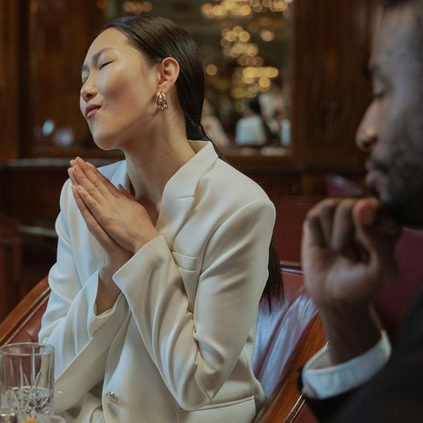 Person feeling refreshed and energetic, smiling lightly with closed eyes.